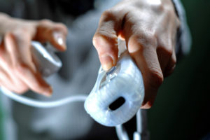 Teenaged boy playing with his Nintendo Wii video game console