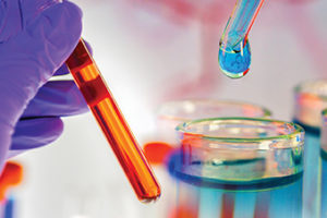 double exposure hand holding test tube merge on chemical dropper