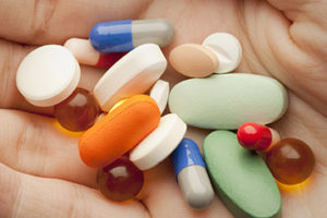 Pills on person's palm