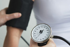 Hands using blood pressure cuff