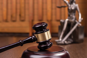 Wooden gavel on wooden table, law concept