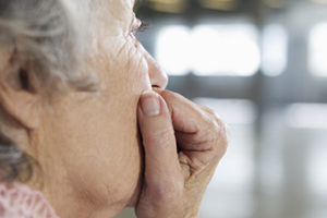 Close up of a depressed old woman