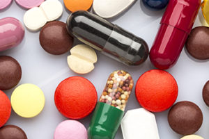 Scattered colorful medical pills and capsules