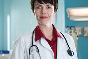 Female doctor in hospital room, portrait