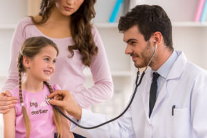 Young Doctor examination little girl with stethoscope