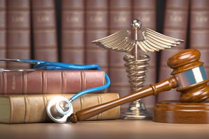 Gavel, stethoscope and caduceus sign on books background. Mediicine laws and legal, medical jurisprudence.
